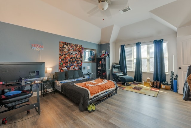 bedroom featuring hardwood / wood-style flooring, ceiling fan, and vaulted ceiling