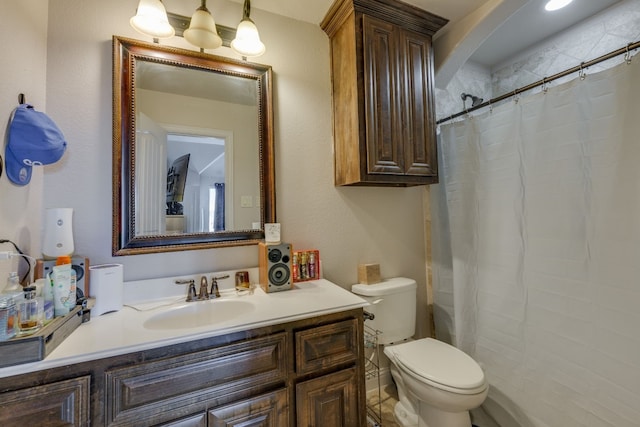 bathroom featuring vanity, a shower with shower curtain, and toilet