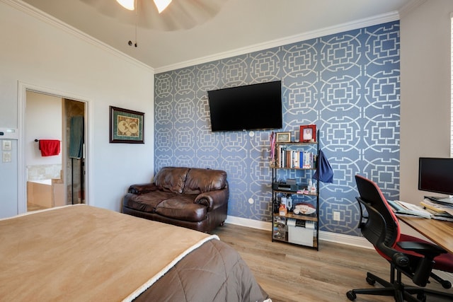 bedroom featuring hardwood / wood-style flooring, crown molding, and connected bathroom