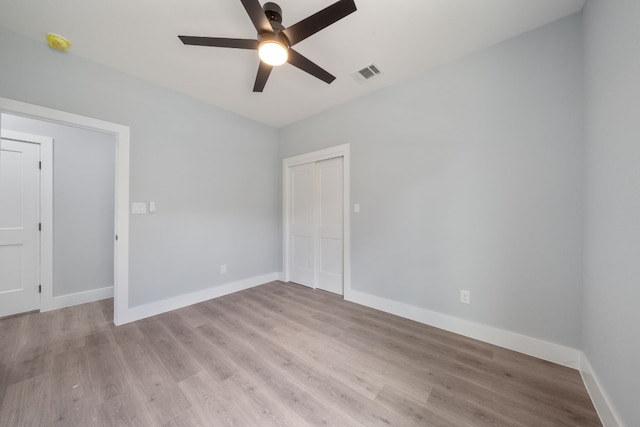 empty room featuring ceiling fan and light wood-type flooring