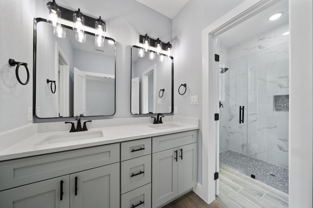 106 Halawa Ct, Bastrop, TX 78602 - full bath featuring a marble finish shower, double vanity, and wood finished floors