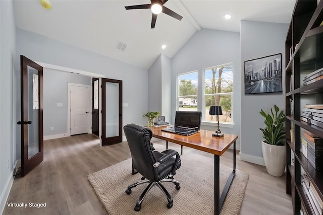 office space featuring french doors, high vaulted ceiling, light wood-type flooring, ceiling fan, and beam ceiling