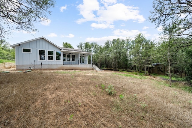 106 Halawa Ct, Bastrop, TX 78602 - back of house with board and batten siding and covered porch