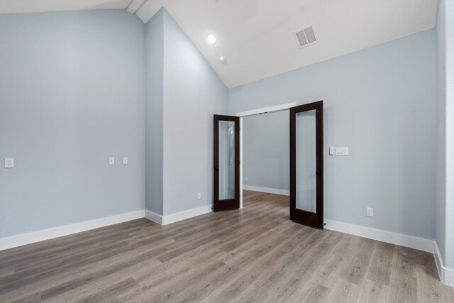 106 Halawa Ct, Bastrop, TX 78602 - unfurnished room with vaulted ceiling and light wood-style flooring