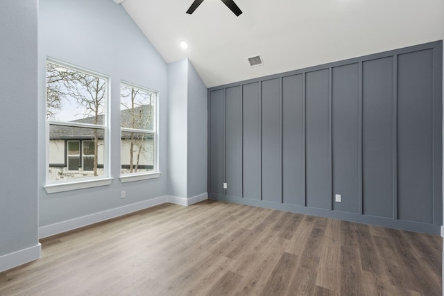 unfurnished room with high vaulted ceiling, ceiling fan, and light wood-type flooring