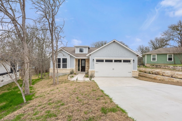106 Halawa Ct, Bastrop, TX 78602 - view of front of house with stone siding, concrete driveway, a garage, and a shingled roof