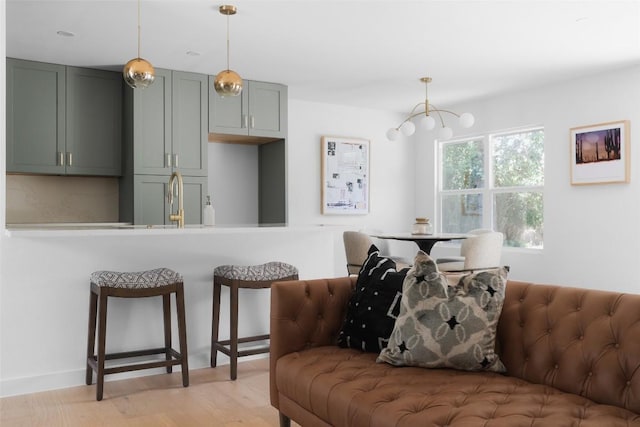 living room with sink and light hardwood / wood-style flooring