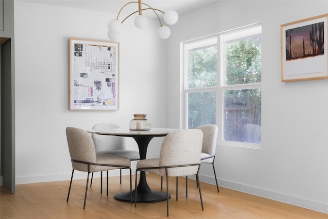 dining room with an inviting chandelier and light hardwood / wood-style floors