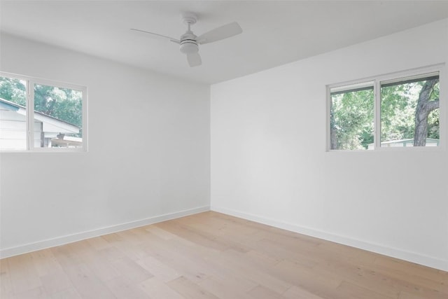 spare room with ceiling fan and light wood-type flooring