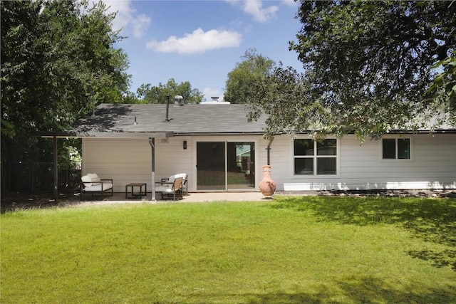 back of house with a patio and a lawn