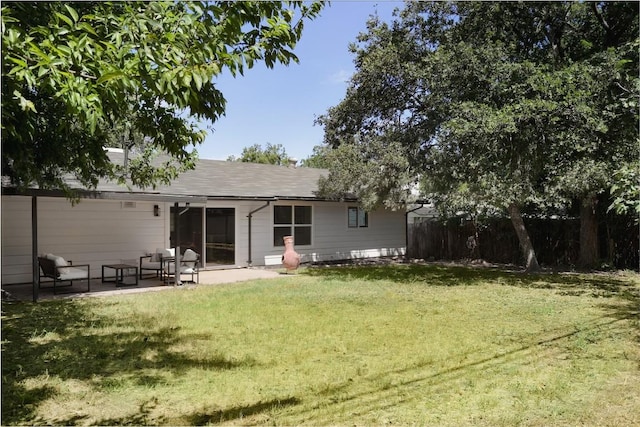 rear view of property featuring a yard and a patio