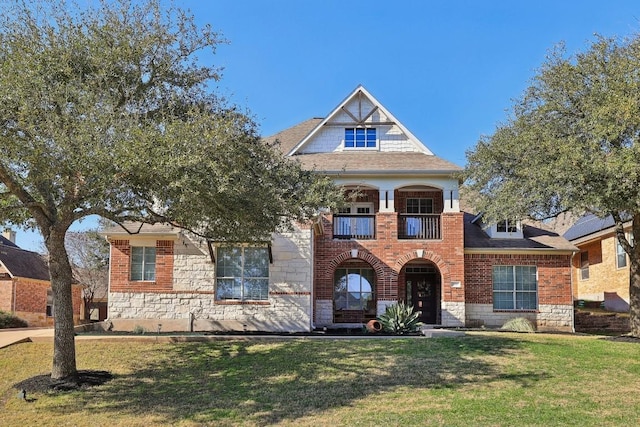 view of front of house with a front yard and a balcony