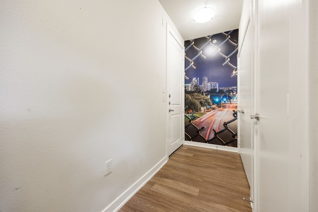 corridor with hardwood / wood-style floors