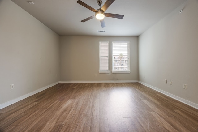 empty room featuring wood-type flooring and ceiling fan