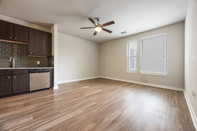 kitchen featuring sink, light hardwood / wood-style flooring, dishwasher, backsplash, and dark brown cabinets