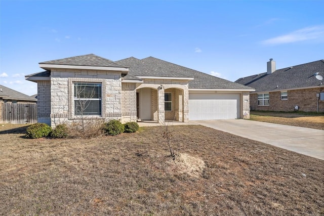 ranch-style house with a garage and a front yard