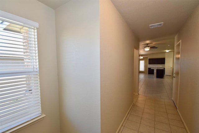 corridor featuring light tile patterned floors