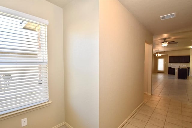 hallway featuring light tile patterned floors