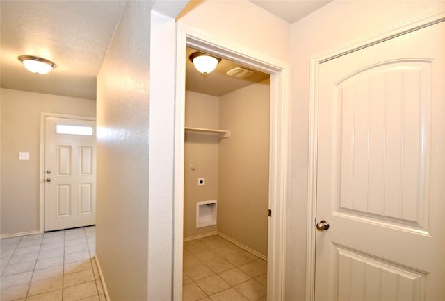 washroom featuring electric dryer hookup and light tile patterned floors