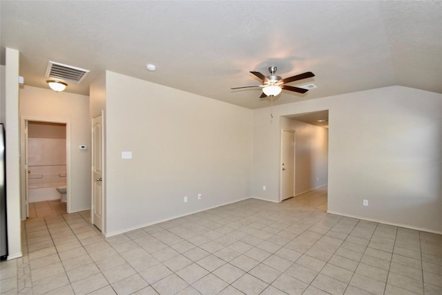 tiled spare room featuring lofted ceiling and ceiling fan