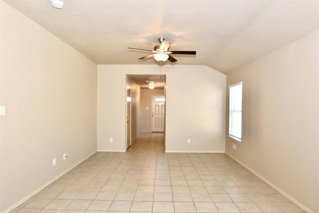 tiled spare room with lofted ceiling and ceiling fan