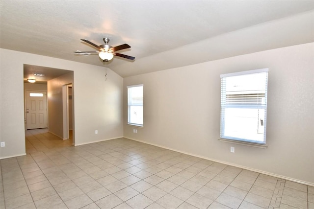 tiled spare room with lofted ceiling and ceiling fan