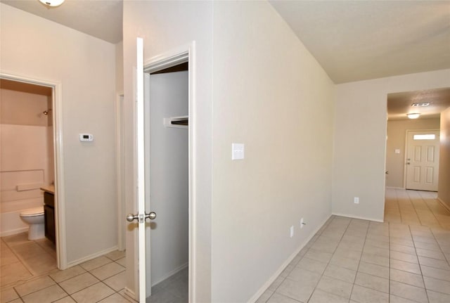 corridor featuring light tile patterned flooring