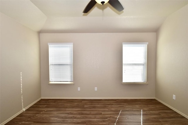 empty room with lofted ceiling, dark wood-type flooring, and ceiling fan