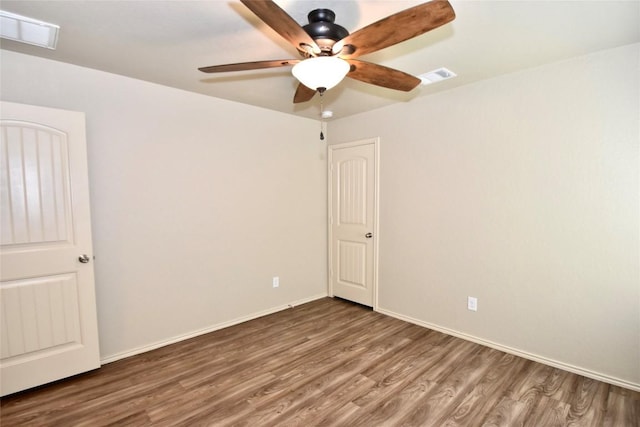 spare room with wood-type flooring