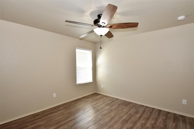 empty room featuring dark wood-type flooring and ceiling fan