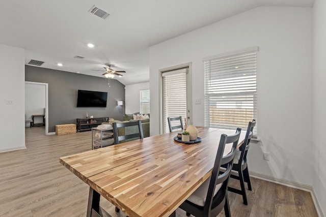 dining area with vaulted ceiling, hardwood / wood-style floors, and ceiling fan