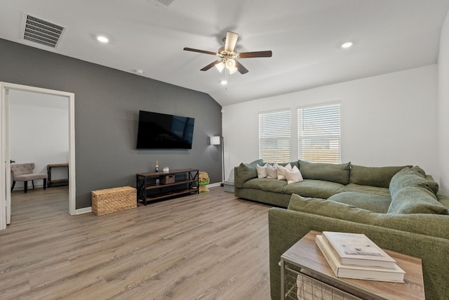 living room featuring lofted ceiling, hardwood / wood-style flooring, and ceiling fan