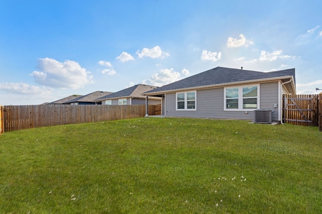 back of property featuring cooling unit and a lawn