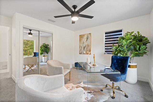 sitting room featuring ceiling fan and light colored carpet