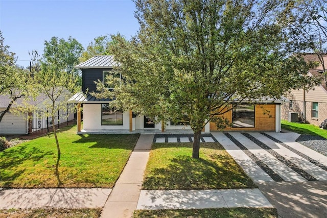 view of front facade featuring cooling unit and a front lawn