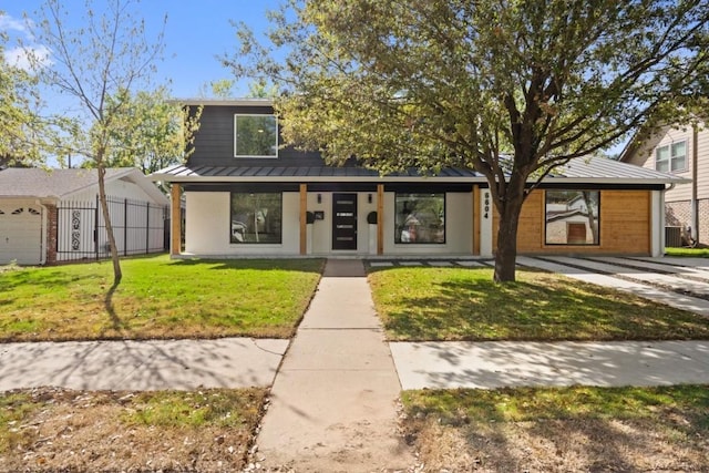 view of front of home with central AC unit, covered porch, and a front lawn