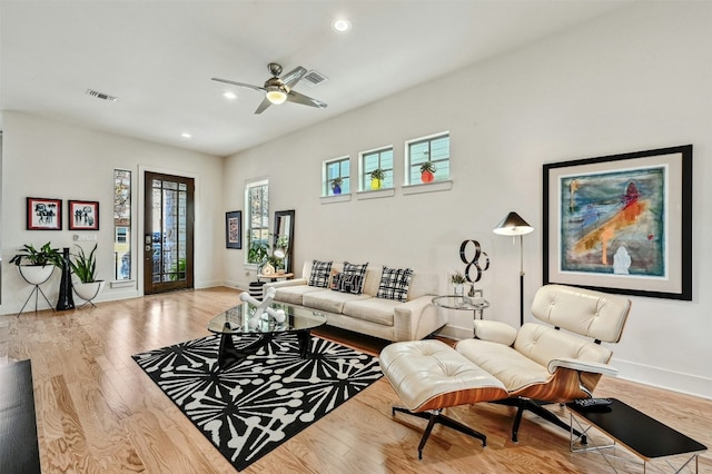 living room featuring ceiling fan and light hardwood / wood-style flooring