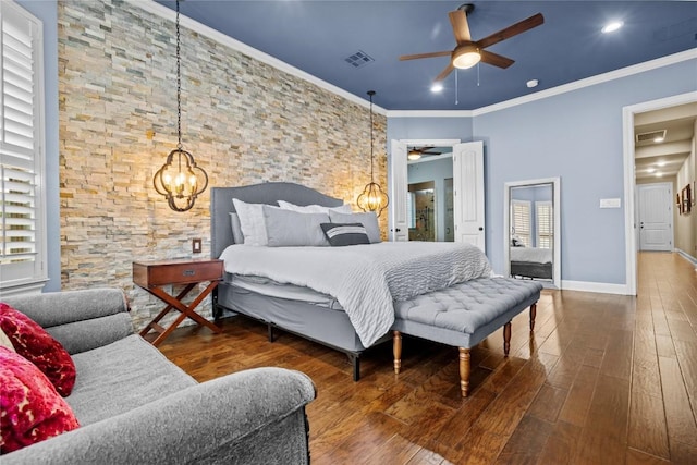 bedroom with crown molding, dark hardwood / wood-style flooring, and a chandelier