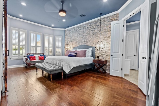 bedroom featuring an inviting chandelier, crown molding, and dark hardwood / wood-style floors