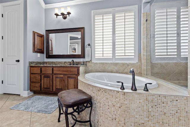 bathroom with crown molding, vanity, tile patterned flooring, and tiled tub