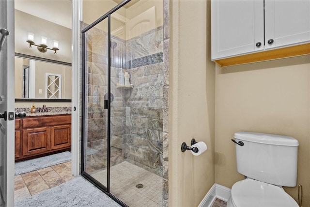 bathroom featuring vanity, toilet, and walk in shower