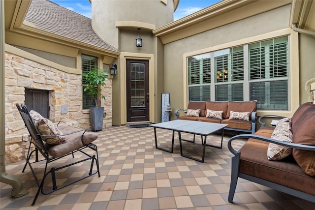 view of patio with an outdoor living space with a fireplace