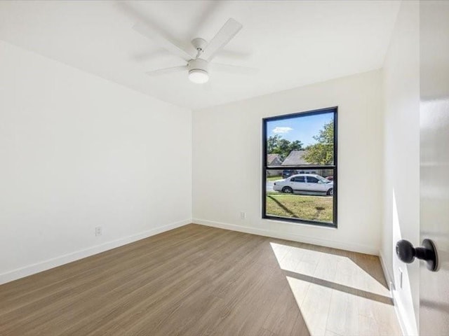 spare room with hardwood / wood-style flooring and ceiling fan