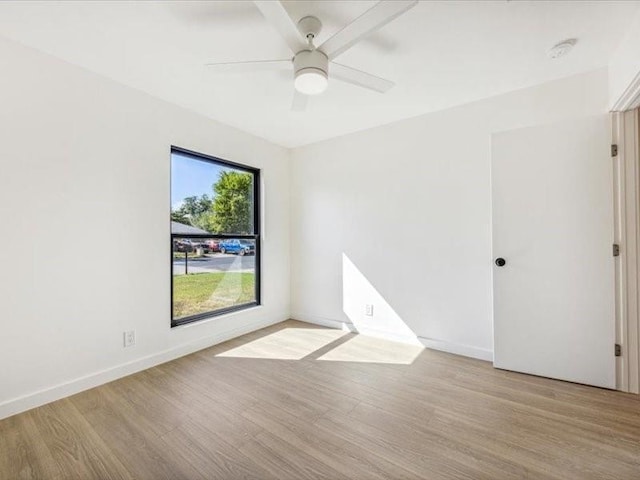 unfurnished room with ceiling fan and light hardwood / wood-style flooring