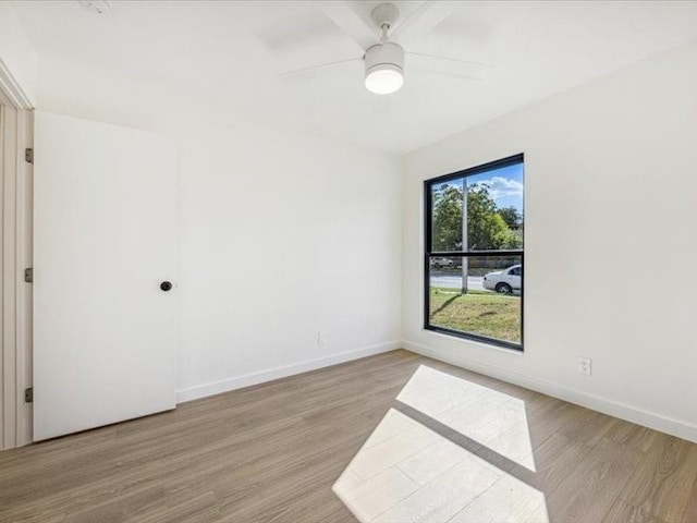 spare room with ceiling fan and light wood-type flooring