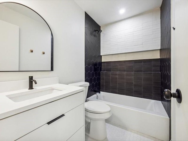 full bathroom featuring vanity, toilet, and tiled shower / bath