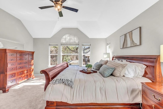 carpeted bedroom featuring lofted ceiling and a ceiling fan