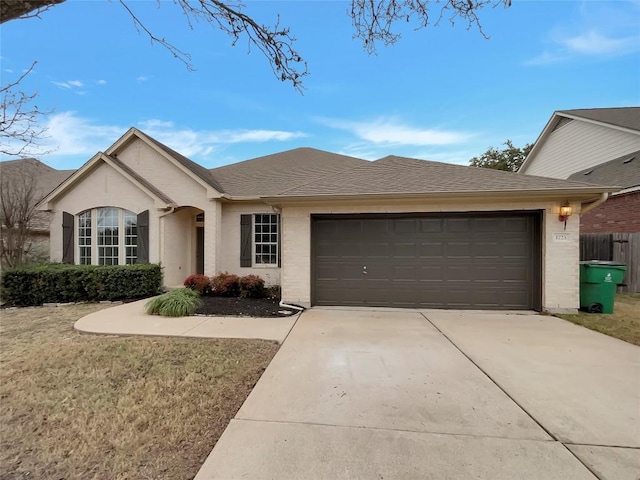 single story home with a garage and a front lawn