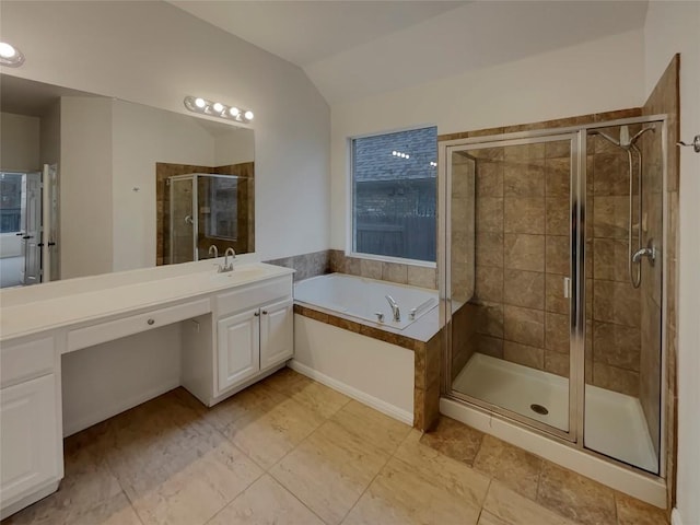 bathroom with lofted ceiling, vanity, and shower with separate bathtub