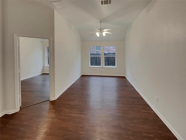 empty room with vaulted ceiling, dark wood-type flooring, and ceiling fan